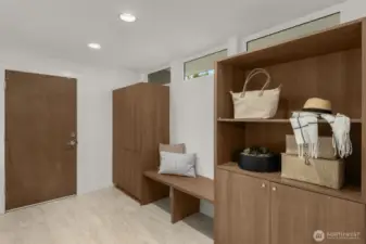 Welcoming entrance off the garage with built-in bench seat and ample storage.