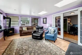 Comfortable library or home office off the upper hall leads to the sunroom.