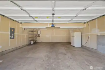 2 Car Garage has overhead racking, shelve and 2nd fridge that stays for new owners.