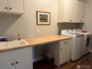 Large laundry room with extra sink and folding countertop.