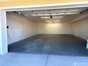 Large 4-car garage with heated floors, doubles as a full-size pickle ball court.