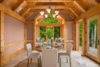 Grand dining room with window seat & french doors leading to deck