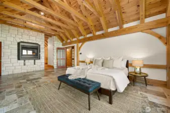 Gas fireplace in primary bedroom, with stone surround