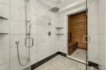 Walk in tile shower with adjoining sauna.