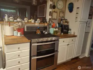 Kitchen stove area and more cabinets!Main house