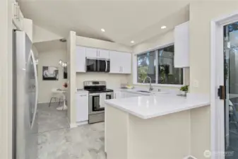 Kitchen opens to eat-in area by patio door and Dining room