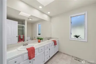 Primary bath hosts dual sinks & shower