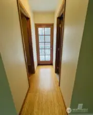 Hallway from primary to bthrm, walk in closet, and balcony