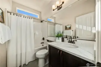 Guest bath with Quart counter and tiled floors.