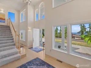 Step inside to the soaring ceiling Entry with gleaming hardwoods & stairs up to Bedrooms & Bonus Room.