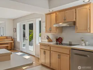 Large open Kitchen with center island, solid cabinets & lots of storage, new stainless steel appliances, subway tiles & fresh paint - overlooks the large Deck & Backyard.