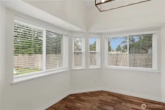 Dining Room surrounded with corner windows, includes new light fixture and blinds.