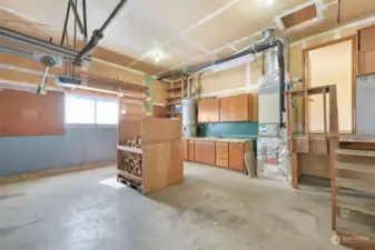 Lots of room in the garage, includes storage cabinets & workspace