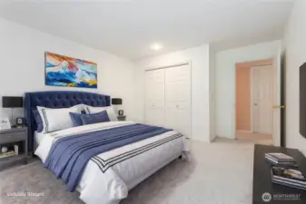 Virtually staged downstairs bedroom #1 featuring generous closet space and a roomy layout.