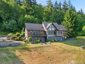 Three tax parcels. The house, the waterfront property to the right and the 5 acres up the hill behind the home.