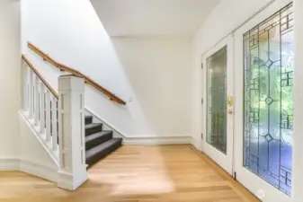 Beautiful glass french doors at the entry and freshly refinished white oak flooring.