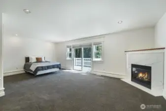 The primary suite features a private balcony, gas fireplace with new quartz slab facing, and an abundance of space.