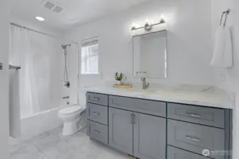 Second level full bath - New vanity with quartz slab countertops, new mirror and light fixture.