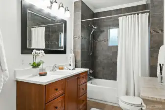 The spa-like bath is remodeled with tiles tub surround and quartz vanity.