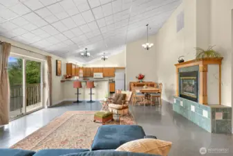 Living room into the kitchen. The celing panels are great for access, but can easily be changed.