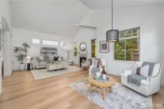 Living room with cozy gas fireplace, new flooring and formal dining or extra sitting space
