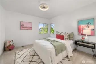 2nd bedroom with ceiling fan and corner windows