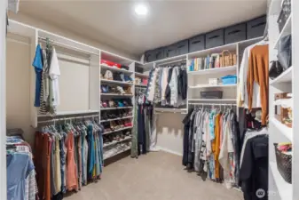 A generous walk-in closet with a fully built-out organization system, offering ample hanging space, shelving, and storage. This well-designed layout keeps everything tidy and easy to access.