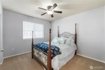 A warm and inviting bedroom sized well for a queen or full bed. Natural light fills the room, and the clean, simple lines make it easy for buyers to picture their own style here.