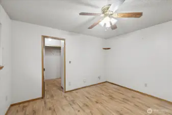 Primary bedroom looking into closet and bath entry