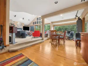 Open entry with oak hardwood flooring and coat closet to the left.