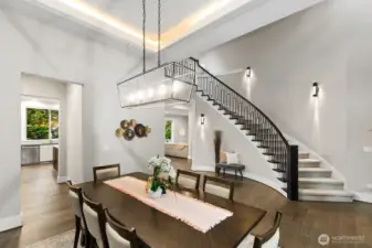 Formal dining room includes coved ceiling with accent lighting.