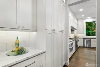 Butler's pantry with with Statuario Quartz countertop. Huge side by side storage cabinets.