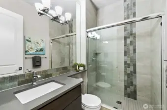 3/4 bath on the main level with custom tile work.