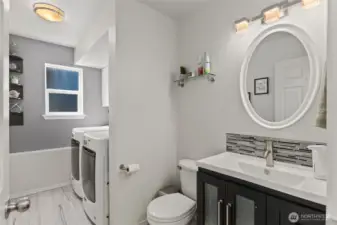 Lower level half bath and laundry room next to the family room.