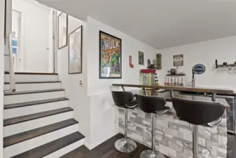 Daylight basement rec room with built in bar and media room.