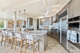 View of open floor plan kitchen off of Family Room with walls of windows encompassing panoramic views!