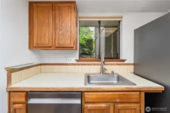 Enjoy the charm of a window above the kitchen sink, perfect for letting in light and fresh air.