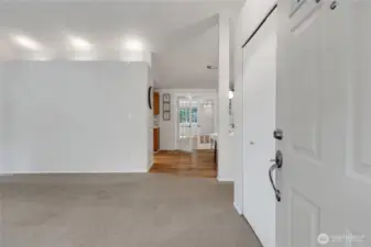 Step inside to a cozy living room with vaulted ceilings that create a bright, open feel.  French doors lead to a spacious great room, offering a perfect flow for entertaining and relaxing.