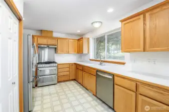 Matching stainless steel appliances in the kitchen along with a large panrty