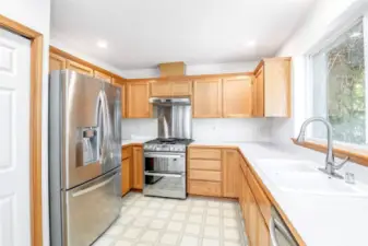 Gas double oven with blue interior and gas cooktop.