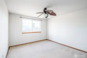 1st bedroom with large leaf fan, front corner of house