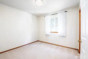 2nd bedroom with beautiful light fixture and walk-in closet, back corner of house