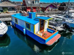The S.S. Guppy brings a burst of color to Lake Union, moored in a friendly, gated marina just steps from the Cheshiahud Loop and moments from Seattle’s skyline.    When you send the rest of the photos, I’ll keep the sequence logical: exterior ? interior ? neighborhood/amenities. Do you want me to format them all in a single document for easy copy-paste when we’re done?