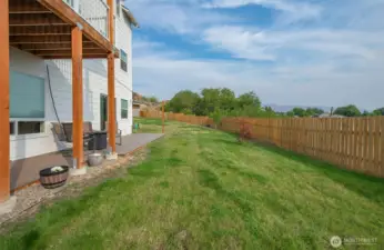 Fenced yard with sitting area off game room