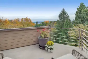 Primary suite view deck among the tree tops looking east towards Lake Washington and Cascade Mountains.
