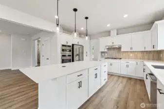 Wall oven microwave and oven.  Cafe style fridge w/bottom freezer.  Large pantry.Pic of similar home, colors and materials may vary