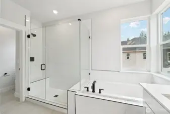 Soaking tub, frameless shower, extensive tile on floor and shower.  Pic of similar home, colors and materials may vary