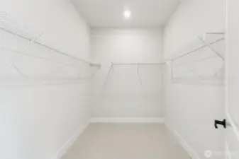 Primary Walk-In closet. Pic of similar home, colors and materials may vary