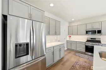 Beautiful kitchen with stunning cabinetry and quartz countertops. Stainless steel appliances offer a sleek, modern look.