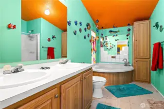 The primary en suite bathromwith dual vanity, stall shower and soaking tub.